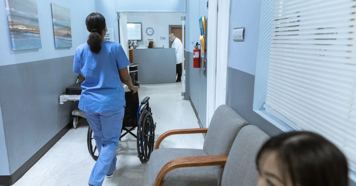 Hospital hallway with healthcare worker pushing a wheelchair, representing medical debt in Canada.